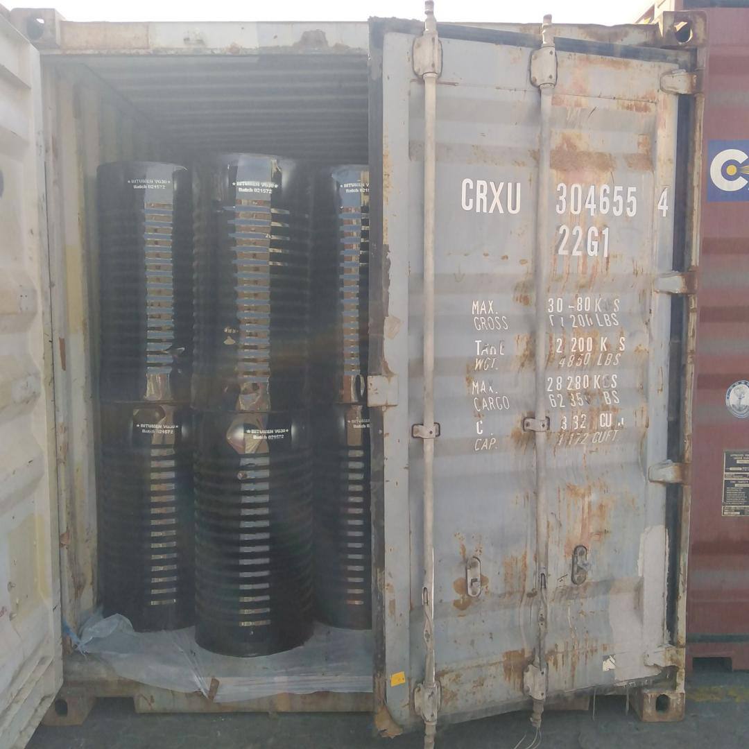 Open 20 foot container loaded with bitumen drums, showing the door specification plate with maximum gross, tare and cargo weights